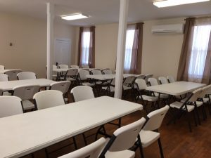 These two pictures show the Main Hall with tables and chairs set up for 60 people.